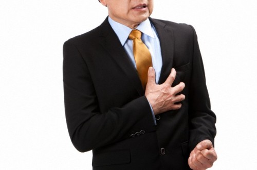Senior businessman suffering from pain on chest